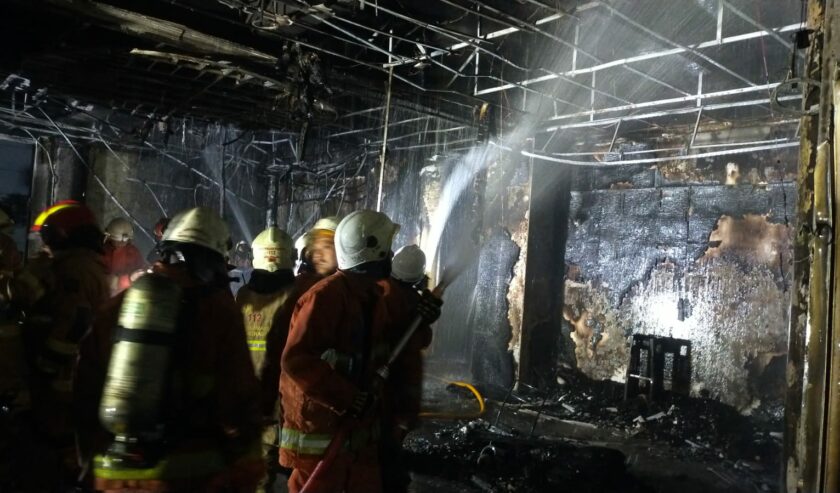 Petugas memadamkan kebakaran di Asrama Bougenvile, Gedung Balai Besar Penjaminan Mutu Pendidikan (BBPMP) Jawa Timur, Jalan Ketintang Wiyata, Surabaya, Jawa Timur, Minggu (27/8/2023). Foto: Command Center Kota Surabaya