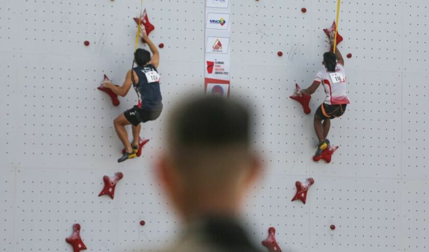 Atlet panjat tebing Indonesia Rahmad Adi Mulyono (kanan) beradu kecepatan dengan atlet Korea Selatan Seungbeom Lee (kiri) saat babak kualifikasi kategori Speed IFSC Asian Qualifier Jakarta 2023 di Arena Panjat Tebing GBK, Jakarta, Minggu (12/11/2023). Foto: Antara