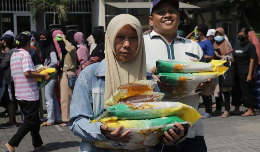 Ilustrasi - Dua orang warga berbelanja bahan pokok saat pasar murah yang digelar oleh Pemkot Surabaya beberapa waktu lalu. Foto: Humas Diskominfo Surabaya