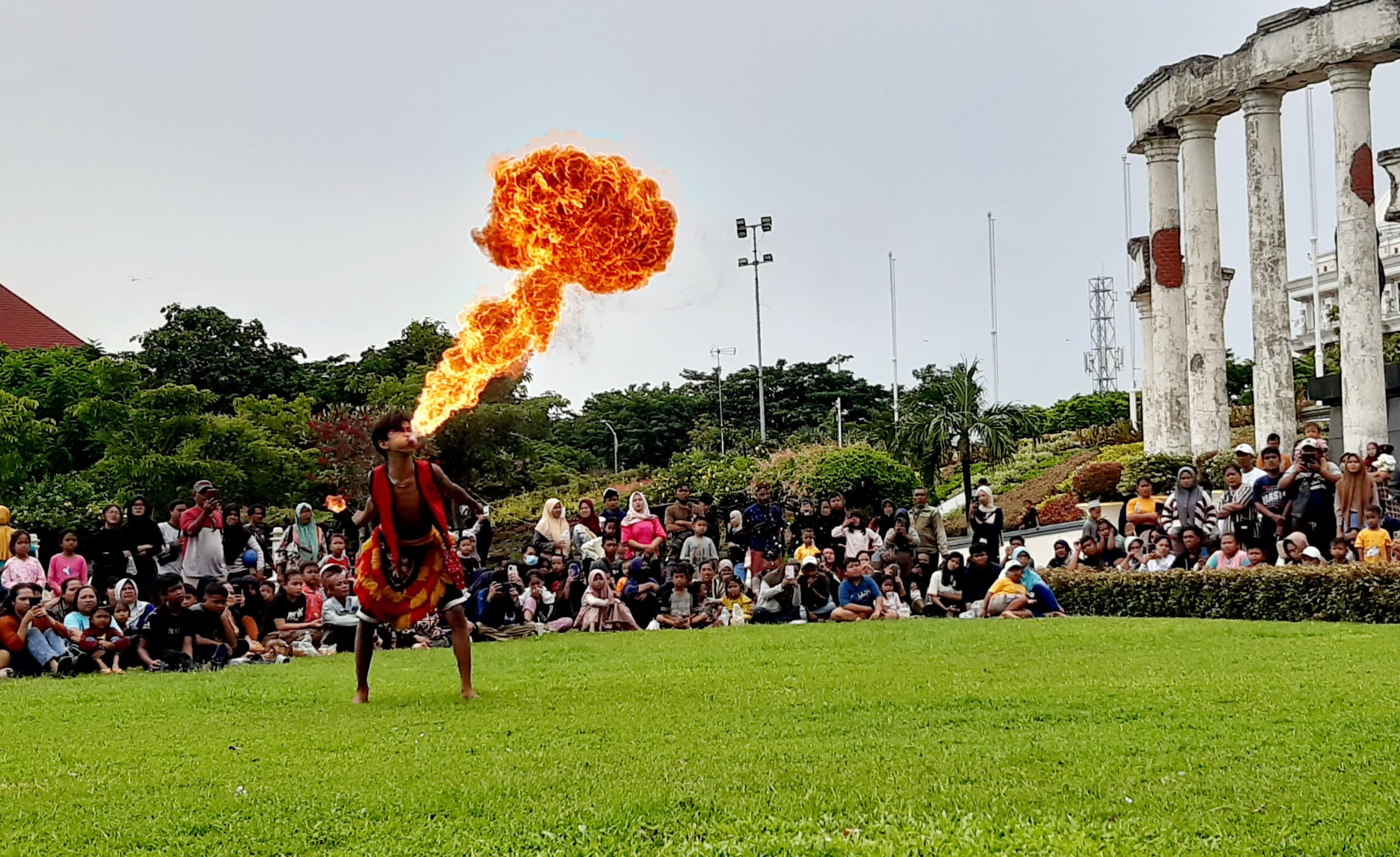 Aksi Bocah Ganong saat menyemburkan api dalam pertunjukan seni Jaranan di Tugu Pahlawan Surabaya, Minggu (10/3/2024). Foto: Ikke magang suarasurabaya.net