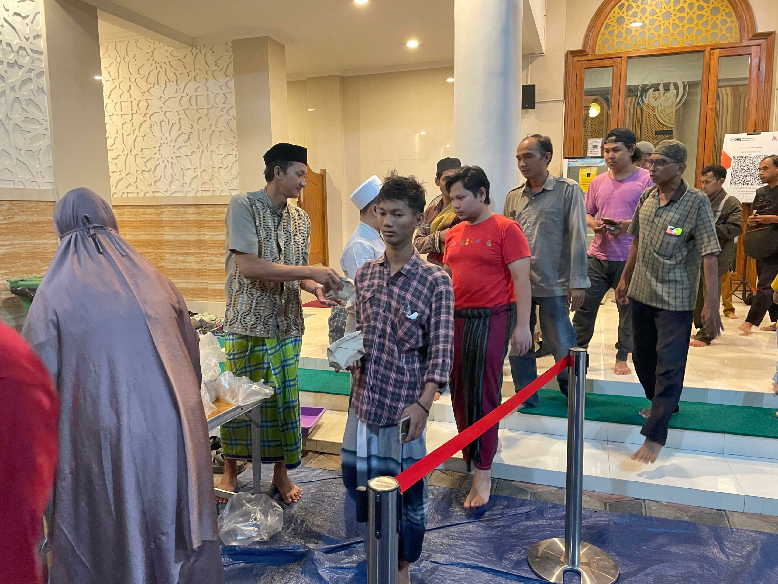 Pembagian nasi bungkus usai Salat Magrib di Masjid Ash-Shoobirin Surabaya, Senin (18/3/2024). Foto: Firman magang suarasurabaya.net